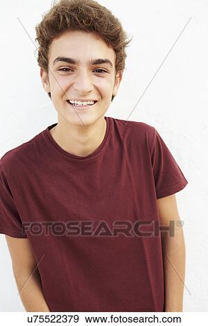 Portrait Of Hispanic Teenage Boy Leaning Against Wall View Large Photo Image Stock Photo - Portrait Of Hispanic Teenage Boy Leaning Against Wall. Fotosearch