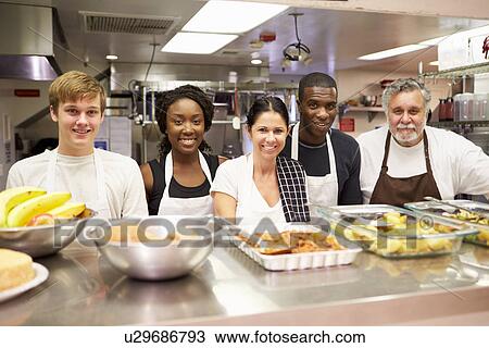 Stock Image - Portrait Of Kitchen Staff In Homeless Shelter. Fotosearch