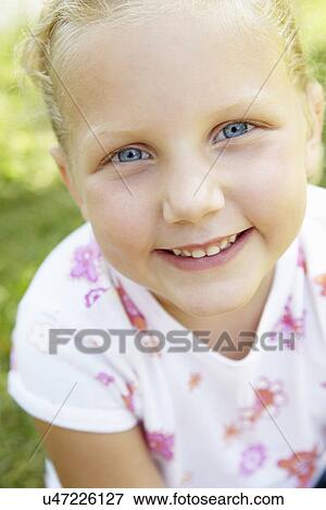 Stock Photo - Portrait of little girl outdoors. Fotosearch