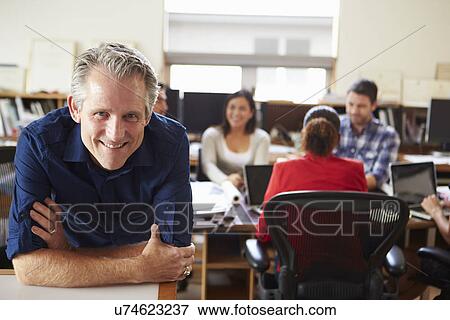 Portrait Of Male Architect With Meeting In Background View Large Photo Image Stock Photo - Portrait Of Male Architect With Meeting In Background. Fotosearch