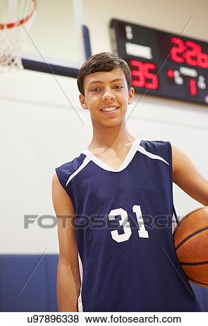 Stock Photo - Portrait Of Male High School Basketball Player. Fotosearch