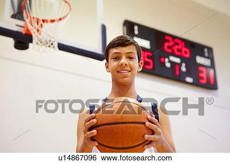 Stock Photograph - Portrait Of Male High School Basketball Player. Fotosearch