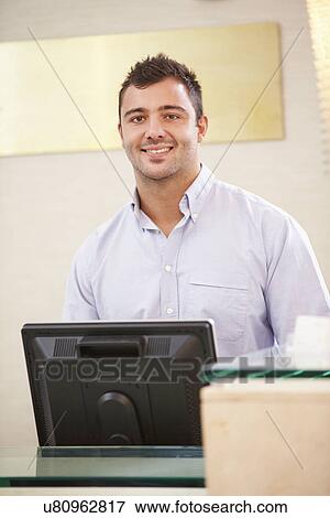 Portrait Of Male Receptionist At Hotel Front Desk View Large Photo Image Stock Photo - Portrait Of Male Receptionist At Hotel Front Desk. Fotosearch