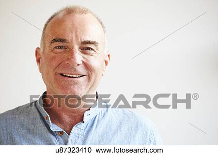 Stock Image - Portrait Of Middle Aged Man Standing By Wall. Fotosearch