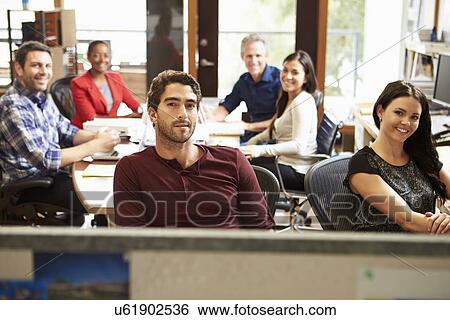 Stock Photograph - Portrait Of Office Staff At Table In Architect's Office. Fotosearch