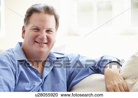 Portrait Of Overweight Man Sitting On Sofa View Large Photo Image Stock Image - Portrait Of Overweight Man Sitting On Sofa. Fotosearch