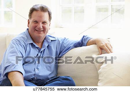 Portrait Of Overweight Man Sitting On Sofa View Large Photo Image Stock Photography - Portrait Of Overweight Man Sitting On Sofa. Fotosearch