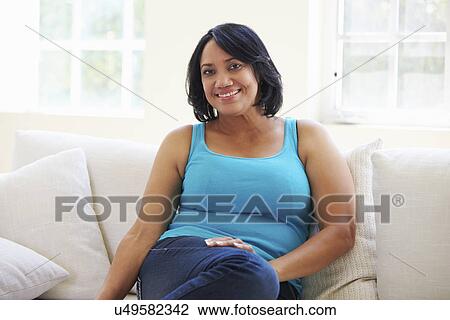 Portrait Of Overweight Woman Sitting On Sofa View Large Photo Image Stock Image - Portrait Of Overweight Woman Sitting On Sofa. Fotosearch