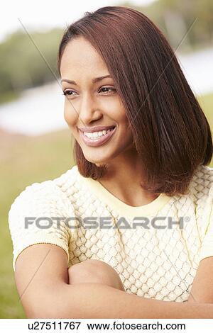 Portrait Of Pretty Young Woman Sitting In Garden View Large Photo Image Stock Photo - Portrait Of Pretty Young Woman Sitting In Garden. Fotosearch