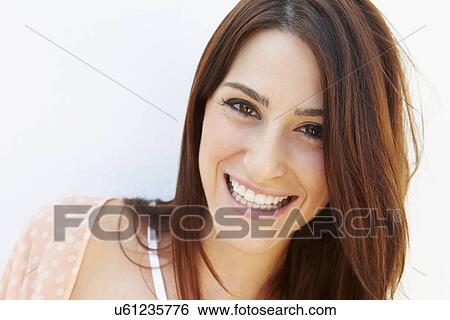 Portrait Of Pretty Young Woman Standing By Wall View Large Photo Image Stock Photograph - Portrait Of Pretty Young Woman Standing By Wall. Fotosearch