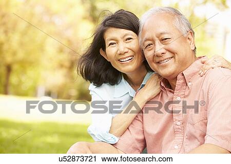 Portrait Of Senior Asian Couple Sitting In Park Together View Large Photo Image Stock Image - Portrait Of Senior Asian Couple Sitting In Park Together. Fotosearch