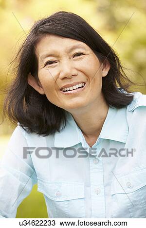 Portrait Of Senior Asian Woman Sitting In Park View Large Photo Image Stock Image - Portrait Of Senior Asian Woman Sitting In Park . Fotosearch