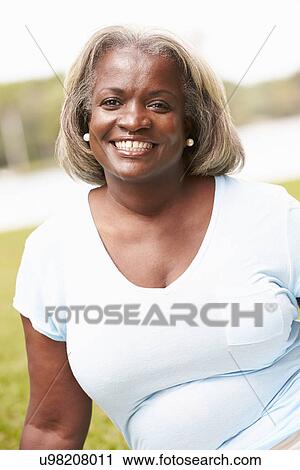 Portrait Of Senior Woman Sitting In Garden View Large Photo Image Stock Image - Portrait Of Senior Woman Sitting In Garden. Fotosearch