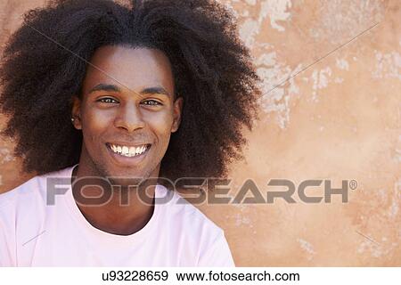 Portrait Of Smiling Man Leaning Against Wall View Large Photo Image Stock Photo - Portrait Of Smiling Man Leaning Against Wall. Fotosearch