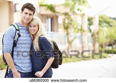 Stock Image - Portrait Of Student Couple Outdoors On University Campus. Fotosearch
