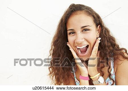 Picture - Portrait Of Teenage Girl Leaning Against Wall Making Face. Fotosearch