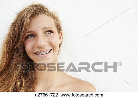 Stock Image - Portrait Of Teenage Girl Leaning Against Wall. Fotosearch