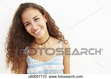 Stock Image - Portrait Of Teenage Girl Leaning Against Wall. Fotosearch