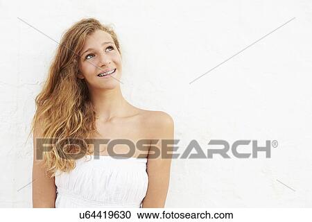 Stock Image - Portrait Of Teenage Girl Leaning Against Wall. Fotosearch