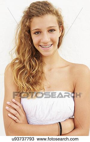 Stock Image - Portrait Of Teenage Girl Leaning Against Wall. Fotosearch