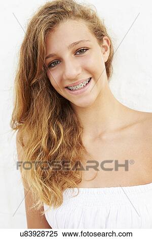Stock Photography - Portrait Of Teenage Girl Leaning Against Wall. Fotosearch