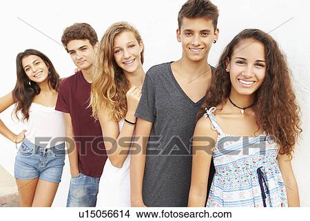 Picture - Portrait Of Teenage Group Leaning Against Wall. Fotosearch