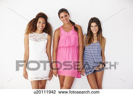 Portrait Of Three Female Friends Leaning Against Wall View Large Photo Image Stock Image - Portrait Of Three Female Friends Leaning Against Wall. Fotosearch