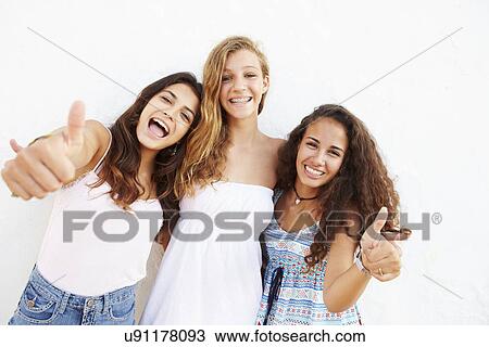 Portrait Of Three Teenage Girls Leaning Against Wall View Large Photo Image Stock Image - Portrait Of Three Teenage Girls Leaning Against Wall. Fotosearch