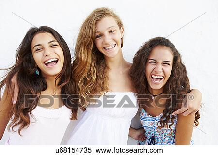 Portrait Of Three Teenage Girls Leaning Against Wall View Large Photo Image Stock Photography - Portrait Of Three Teenage Girls Leaning Against Wall. Fotosearch