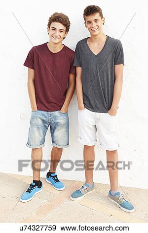 Portrait Of Two Hispanic Teenage Boys Leaning Against Wall View Large Photo Image Stock Photo - Portrait Of Two Hispanic Teenage Boys Leaning Against Wall. Fotosearch