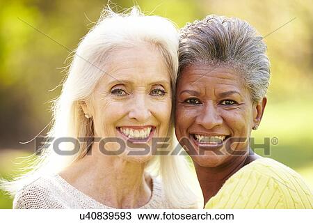 Portrait Of Two Mature Female Friends Hugging View Large Photo Image Stock Image - Portrait Of Two Mature Female Friends Hugging. Fotosearch