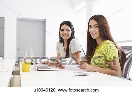 Stock Image - Portrait Of Two Women Working Together In Design Studio. Fotosearch