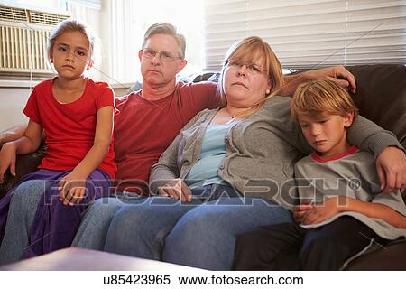 Portrait Of Unhappy Family Sitting On Sofa Together View Large Photo Image Stock Photography - Portrait Of Unhappy Family Sitting On Sofa Together. Fotosearch