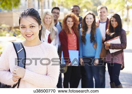 Stock Image - Portrait Of University Students Outdoors On Campus. Fotosearch