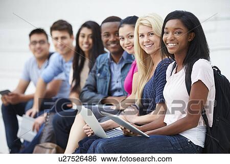 Stock Photograph - Portrait Of University Students Outdoors On Campus. Fotosearch