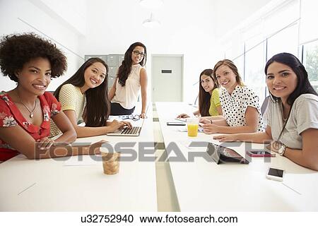 Stock Image - Portrait Of Women Working Together In Design Studio. Fotosearch