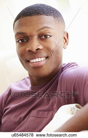 Portrait Of Young Man Relaxing Sitting On Sofa View Large Photo Image Stock Photo - Portrait Of Young Man Relaxing Sitting On Sofa. Fotosearch