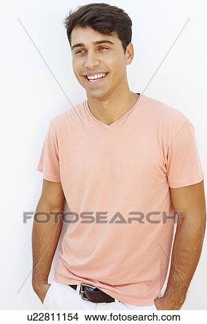 Picture - Portrait Of Young Man Standing By Wall. Fotosearch