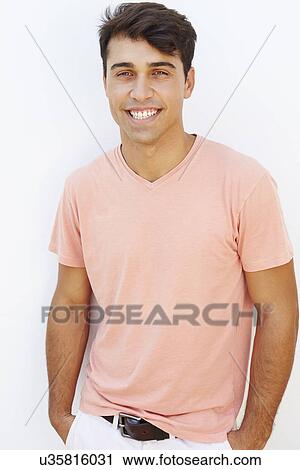 Stock Image - Portrait Of Young Man Standing By Wall. Fotosearch