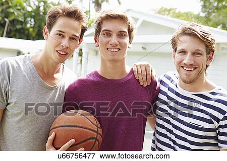 Stock Photo - Portrait Of Young Men Playing Basketball Match. Fotosearch