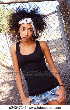 Portrait Of Young Woman In Urban Setting Standing By Fence View Large Photo Image Stock Photography - Portrait Of Young Woman In Urban Setting Standing By Fence. Fotosearch