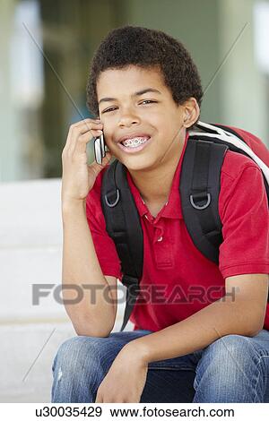 Pre teen boy with phone at school View Large Photo Image Stock Photo - Pre teen boy with phone at school. Fotosearch
