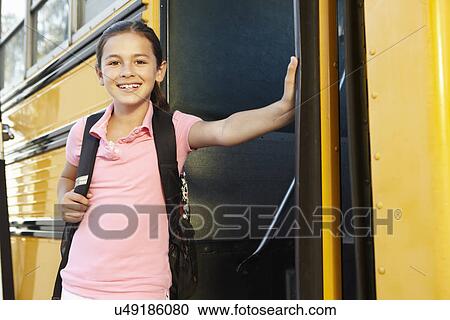 Pre teen girl getting on school bus View Large Photo Image Stock Image - Pre teen girl getting on school bus. Fotosearch