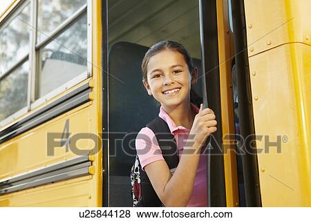 Pre teen girl getting on school bus View Large Photo Image Stock Photo - Pre teen girl getting on school bus. Fotosearch