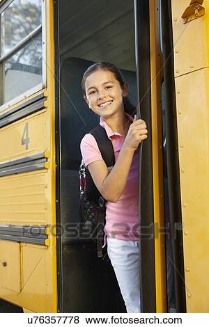 Stock Photo - Pre teen girl getting on school bus. Fotosearch