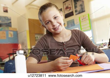 Stock Image - Pre teen girl in art and craft class. Fotosearch