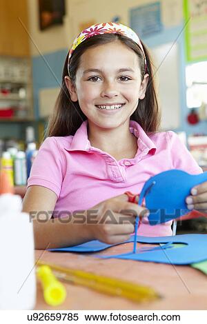 Stock Photography - Pre teen girl in art and craft class. Fotosearch