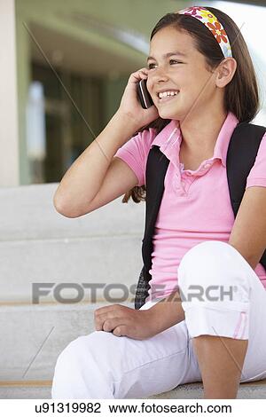 Pre teen girl with phone at school View Large Photo Image Stock Image - Pre teen girl with phone at school. Fotosearch