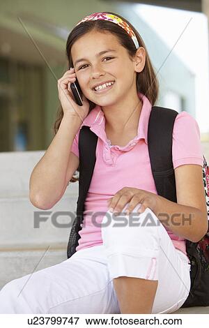 Pre teen girl with phone at school View Large Photo Image Stock Photo - Pre teen girl with phone at school. Fotosearch