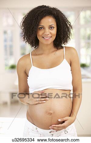 Pregnant woman at home View Large Photo Image Picture - Pregnant woman at home. Fotosearch
